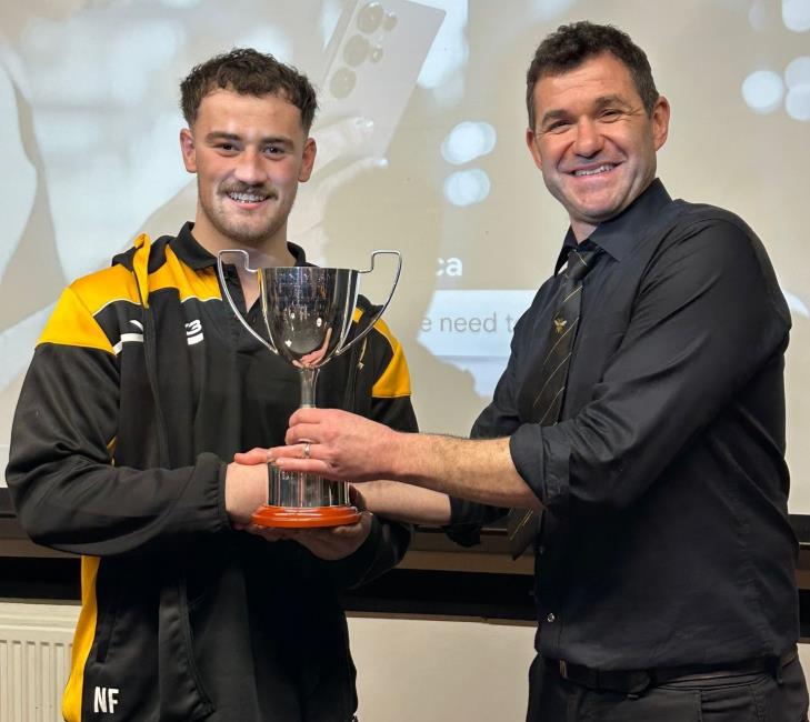 Nathan Foster receives the Johnny James Trophy from Danny Chesmer